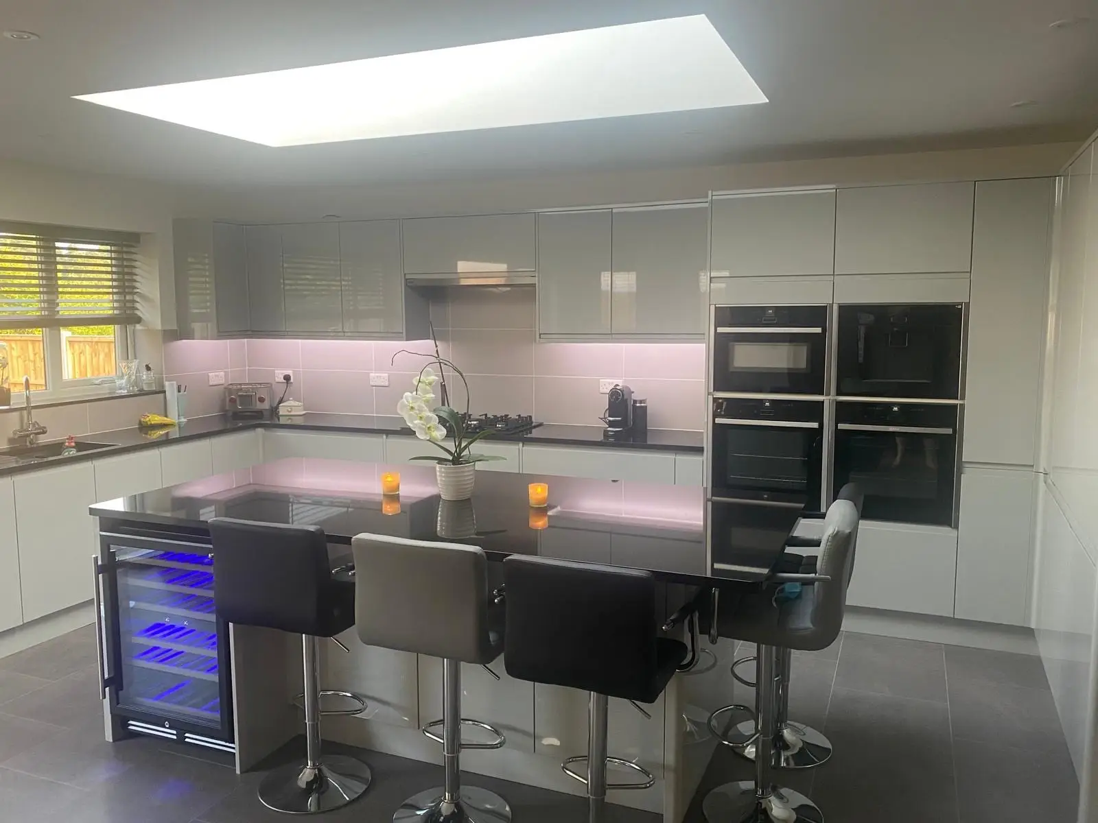 The finished kitchen with an island and a large flat rooflight overhead