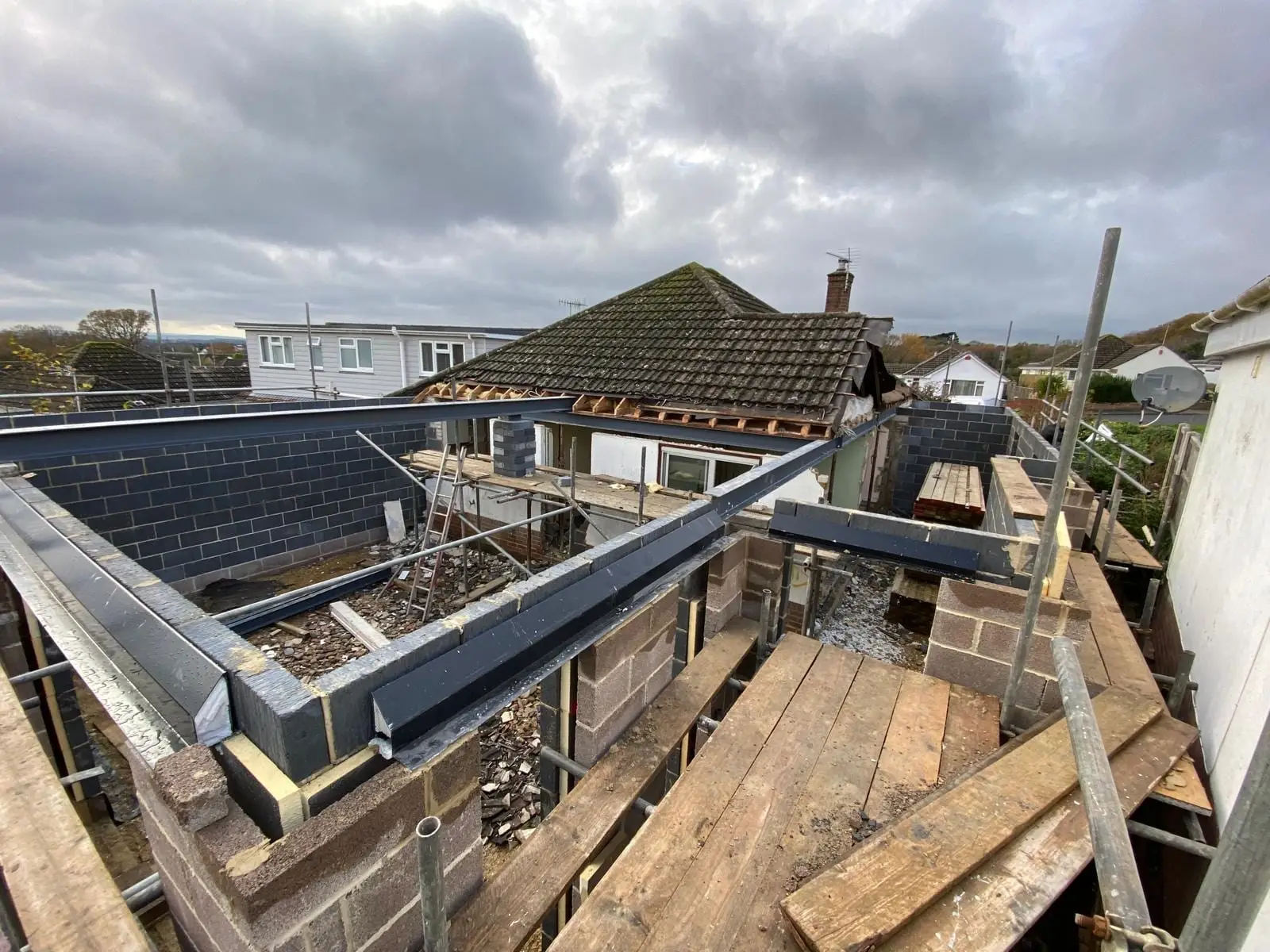 The roof stripped back to the rafters with the new steel ring beam sitting on fresh blockwork