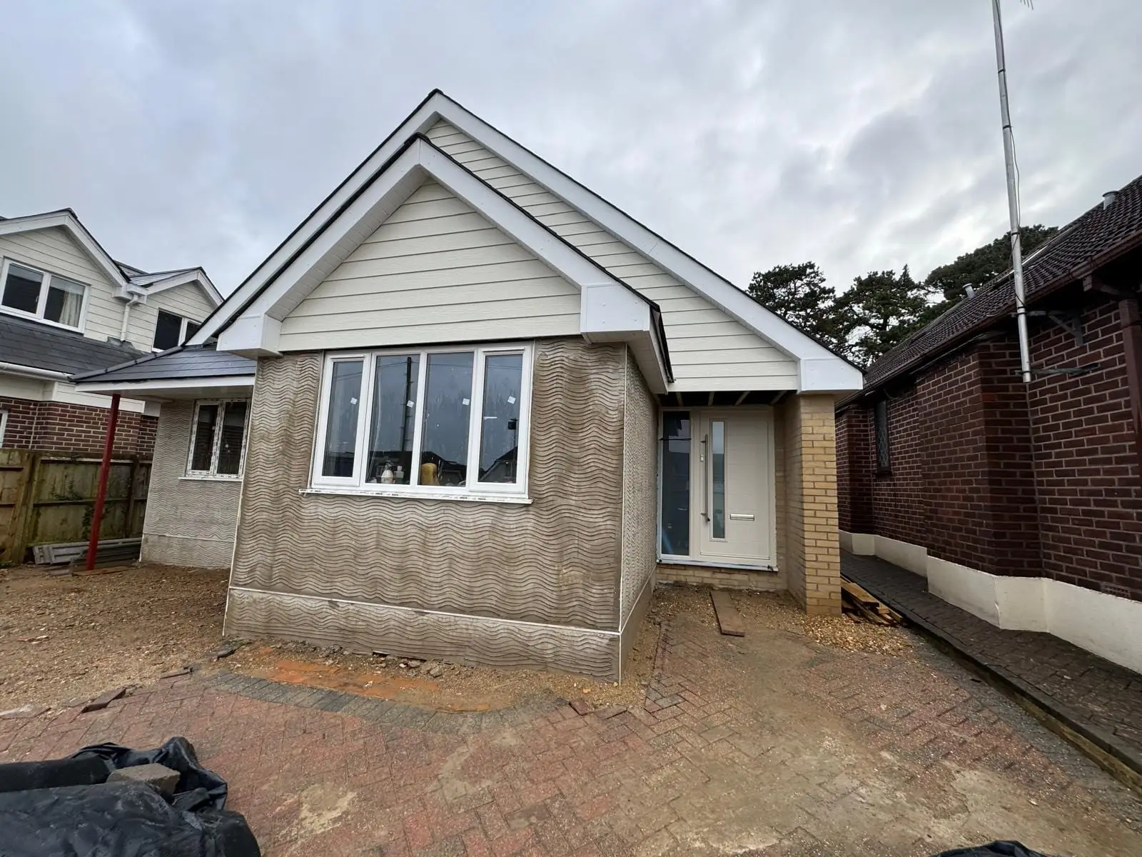 A bungalow raised to a chalet house, rendered and clad and close to finished