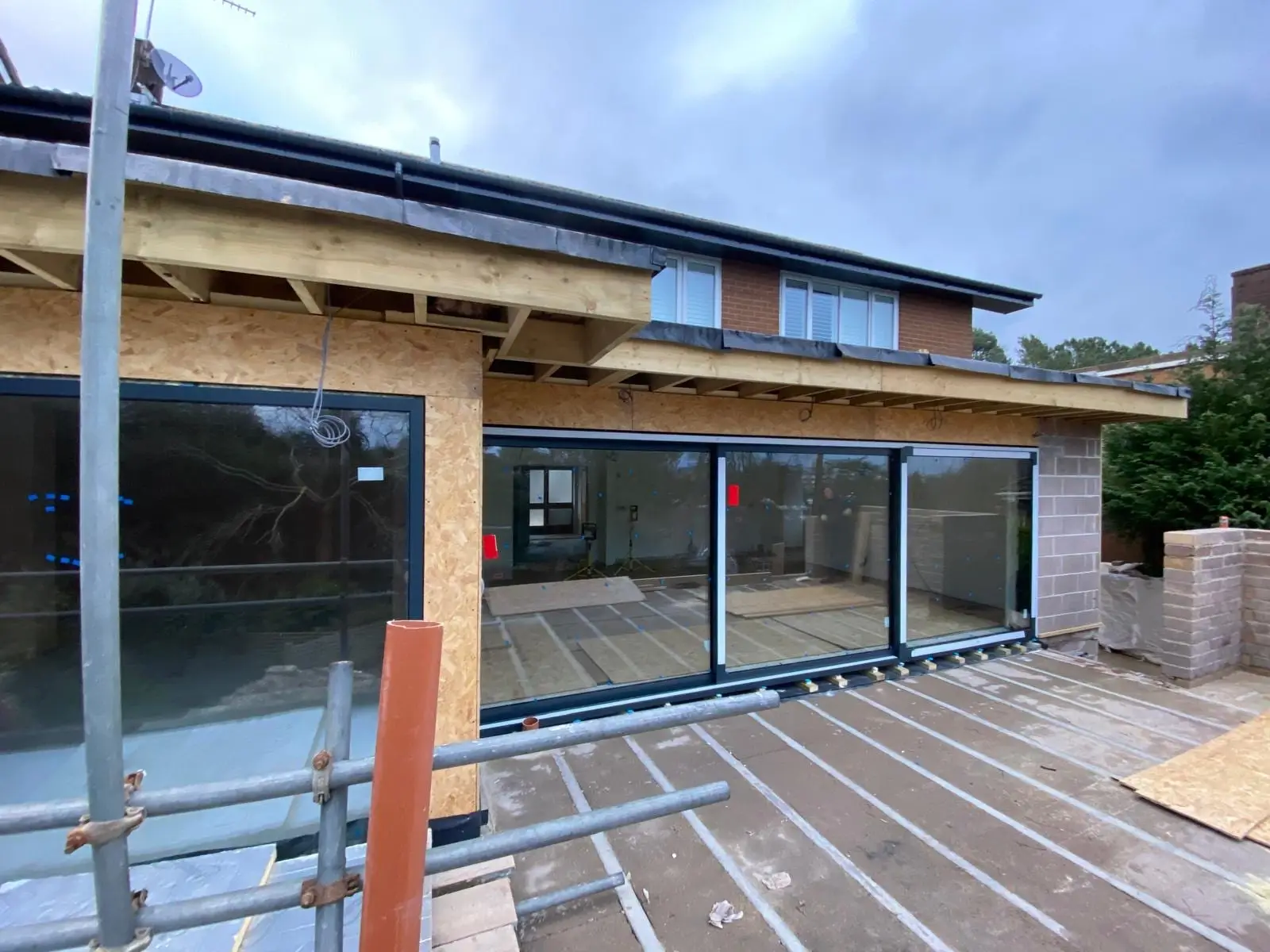 The aluminium sliding doors installed under the exposed rafter roof