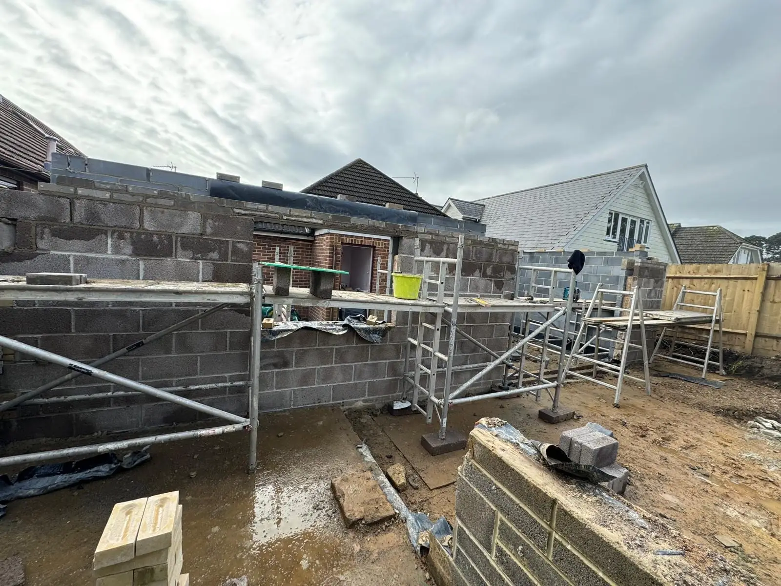 Blockwork walls up to plate height on a new build shell, with the scaffold up