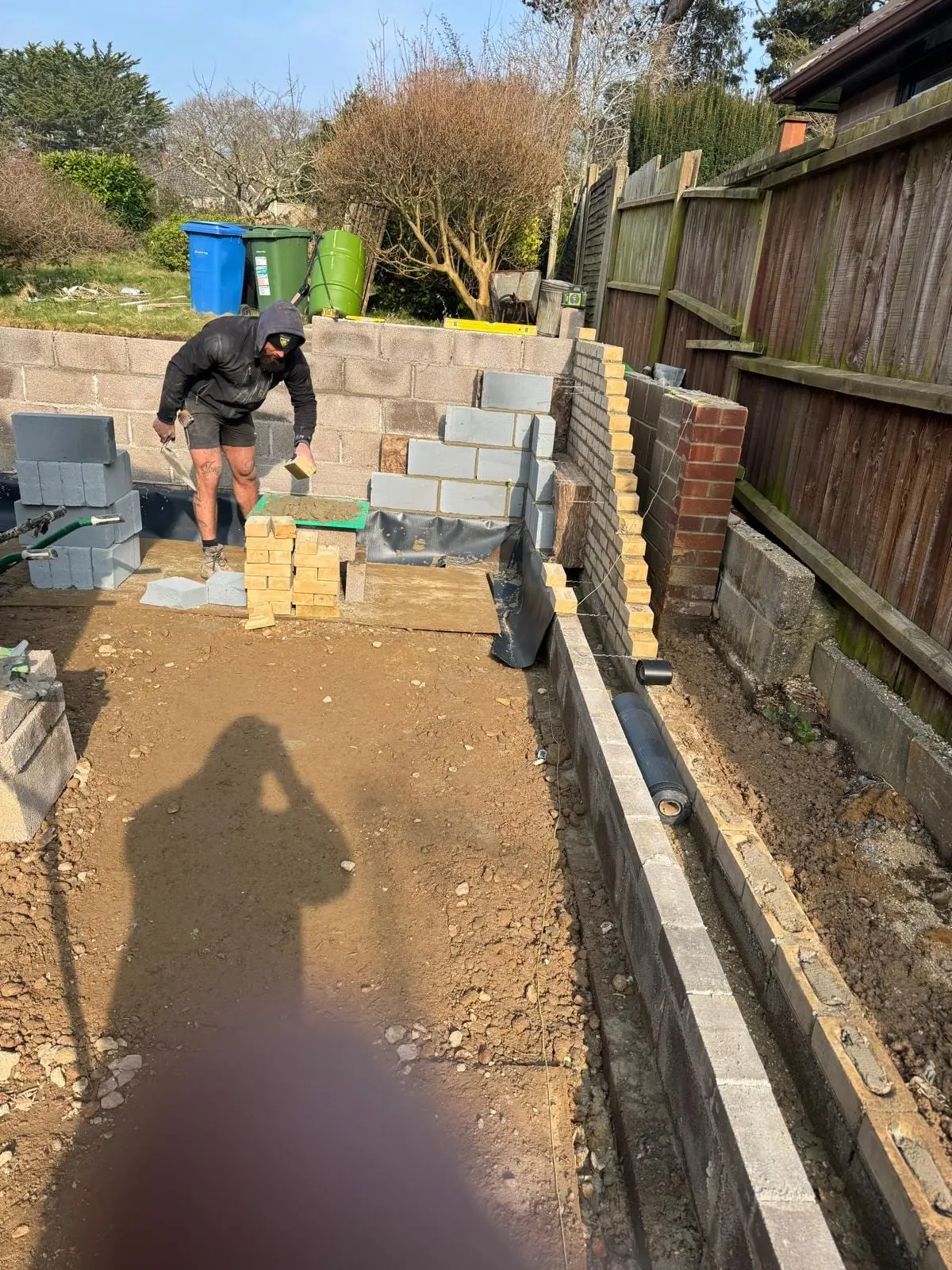Laying blocks and bricks on a new garden wall